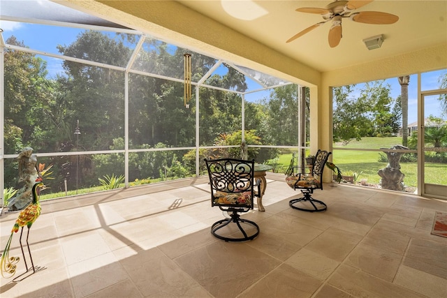 sunroom / solarium with a wealth of natural light and ceiling fan