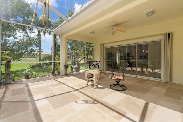 unfurnished sunroom featuring ceiling fan