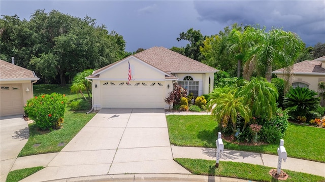 view of front of home with a garage and a front yard