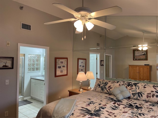 tiled bedroom featuring lofted ceiling, connected bathroom, sink, and ceiling fan