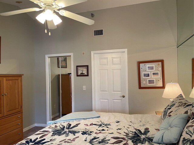 bedroom featuring ceiling fan, a closet, carpet floors, and vaulted ceiling