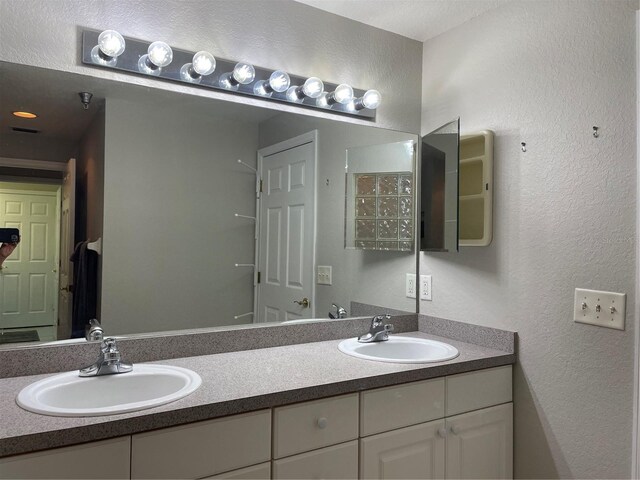 bathroom featuring a textured ceiling and vanity