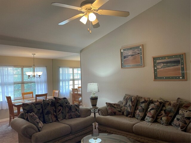 carpeted living room featuring lofted ceiling and ceiling fan with notable chandelier