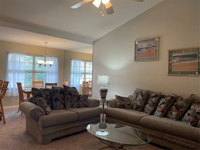 carpeted living room featuring lofted ceiling and ceiling fan with notable chandelier