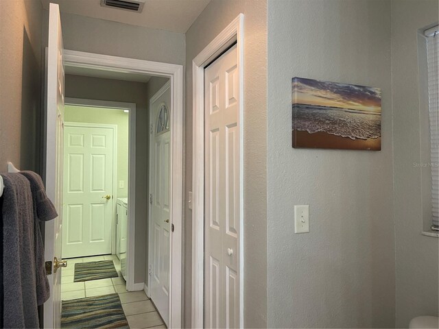 hall featuring light tile patterned flooring