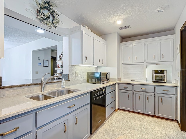 kitchen featuring sink, a textured ceiling, white cabinets, and tasteful backsplash