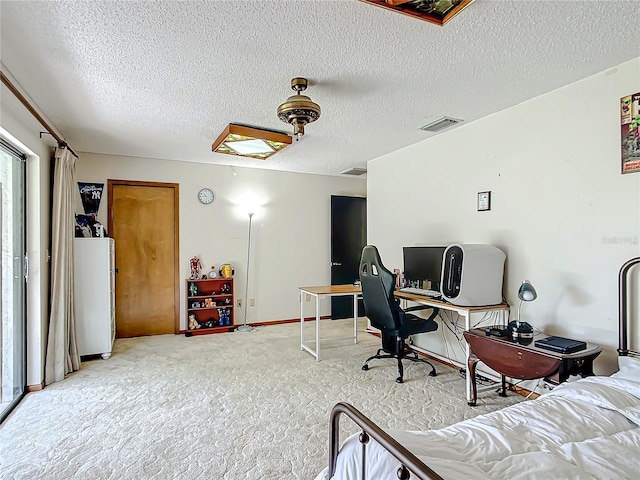 office space with a textured ceiling, ceiling fan, and carpet floors