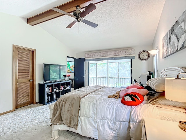 bedroom with ceiling fan, carpet, access to exterior, lofted ceiling with beams, and a textured ceiling