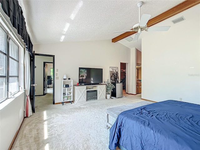 bedroom featuring ceiling fan, a textured ceiling, and lofted ceiling with beams