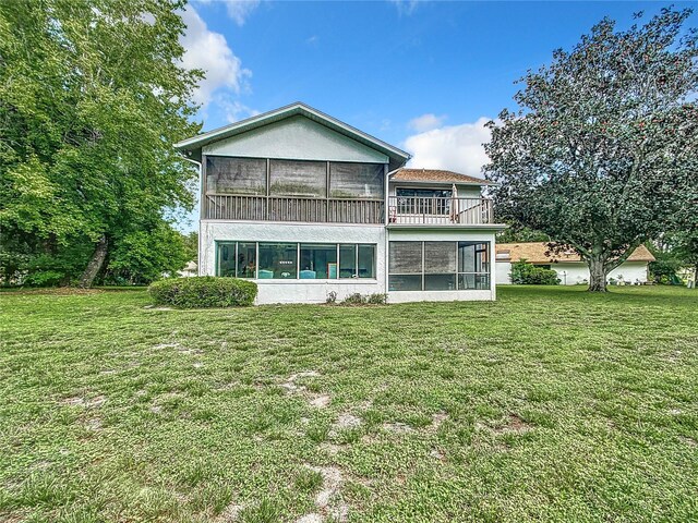 back of house featuring a sunroom and a yard