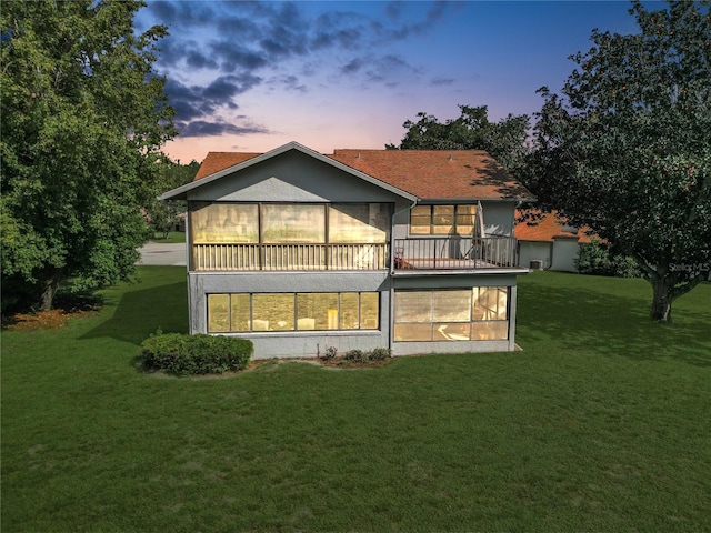 back house at dusk with a yard