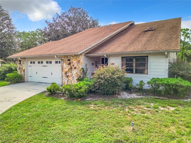 ranch-style house with a garage and a front lawn