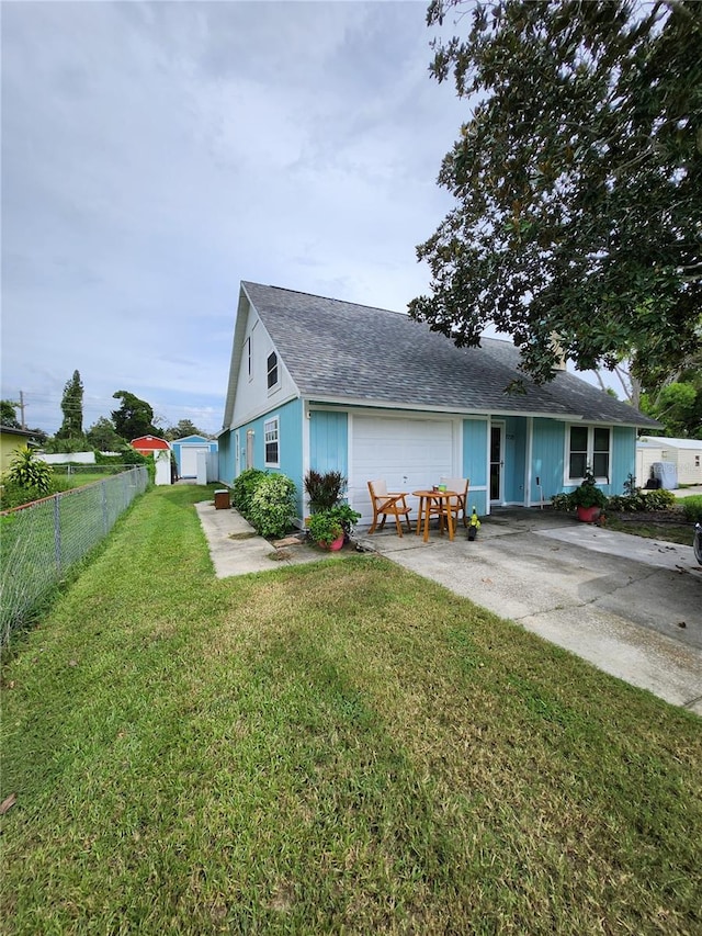 view of front of home featuring a garage and a front lawn