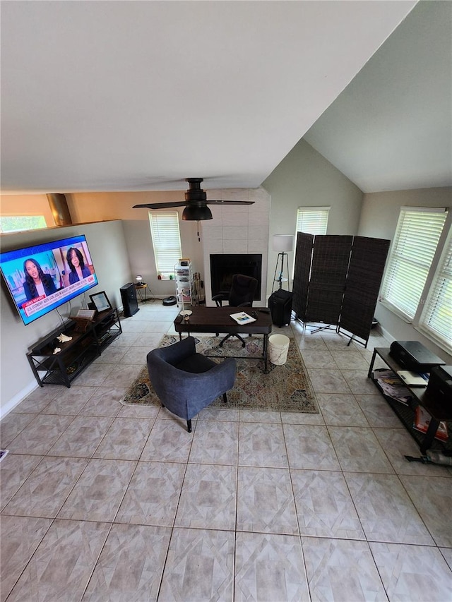 living room with light tile patterned floors, lofted ceiling, ceiling fan, and a fireplace