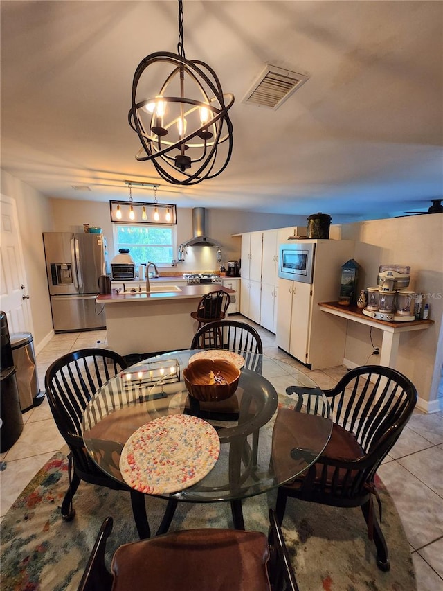 dining room with a chandelier and light tile patterned floors