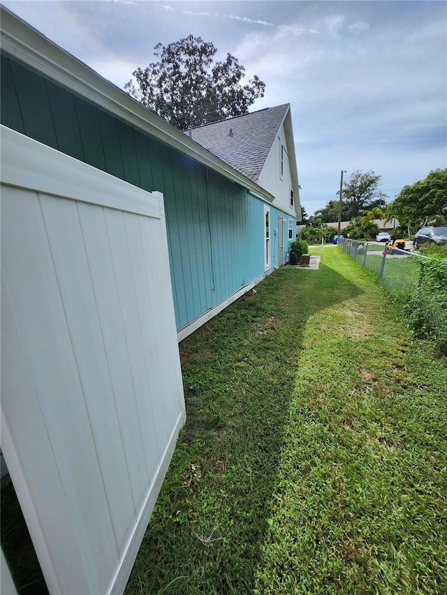 view of side of property with a lawn