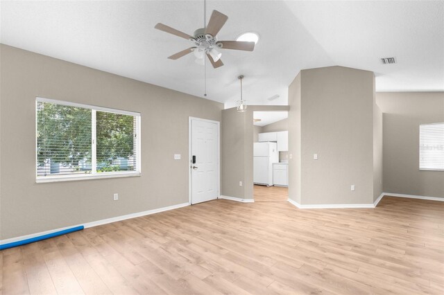 unfurnished living room with ceiling fan, lofted ceiling, and light wood-type flooring