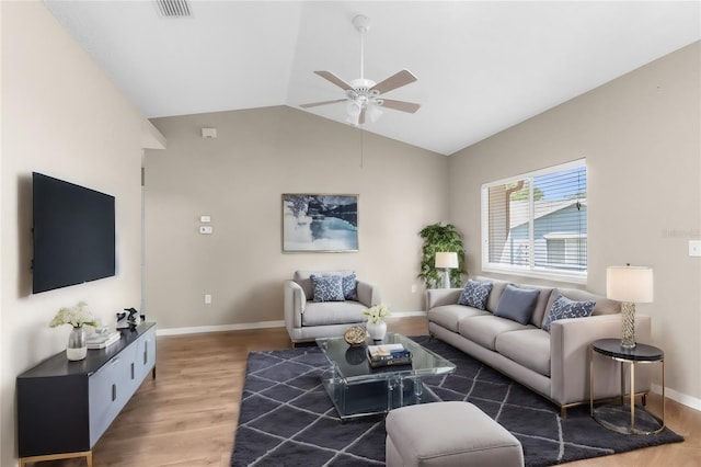 living room with ceiling fan, hardwood / wood-style floors, and lofted ceiling