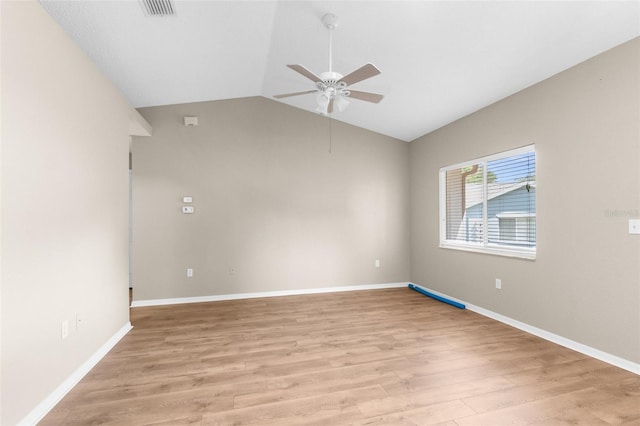 spare room with ceiling fan, light hardwood / wood-style floors, and vaulted ceiling