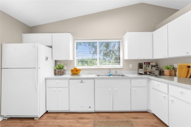 kitchen featuring lofted ceiling, white appliances, sink, light wood-type flooring, and white cabinetry