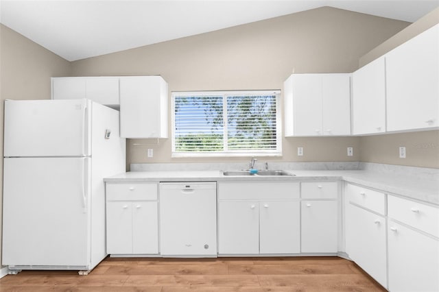 kitchen with white cabinets, white appliances, lofted ceiling, and sink