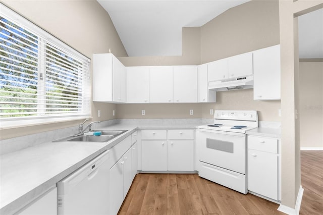 kitchen with white cabinets, white appliances, sink, and vaulted ceiling