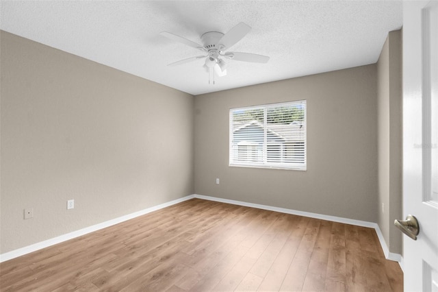 unfurnished room with a textured ceiling, light hardwood / wood-style floors, and ceiling fan