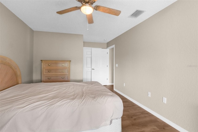 bedroom featuring ceiling fan and dark wood-type flooring