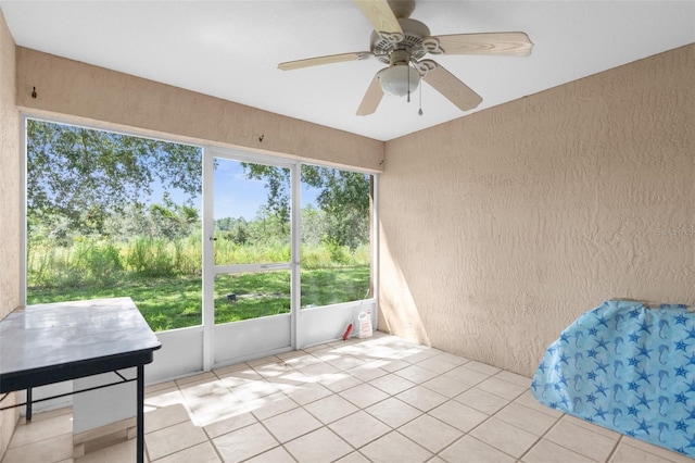 sunroom / solarium with a wealth of natural light and ceiling fan