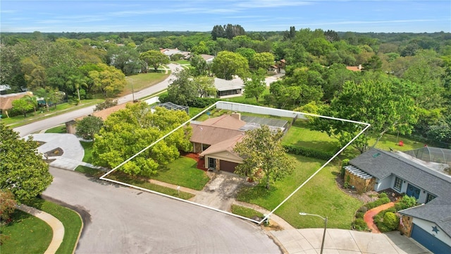 birds eye view of property with a wooded view