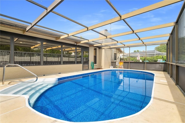 view of pool featuring glass enclosure and a patio