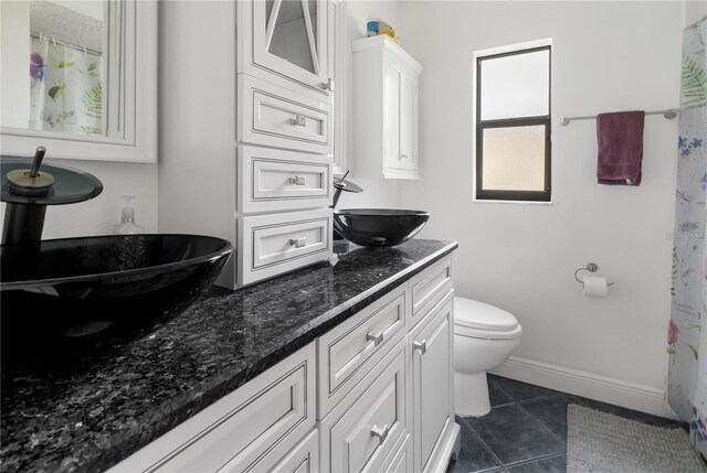 bathroom with vanity, toilet, and tile patterned flooring