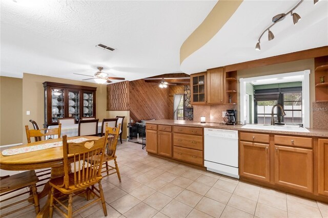 kitchen with dishwasher, light tile patterned floors, sink, decorative backsplash, and ceiling fan