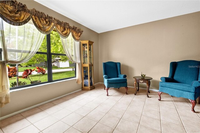 sitting room featuring light tile patterned floors and plenty of natural light