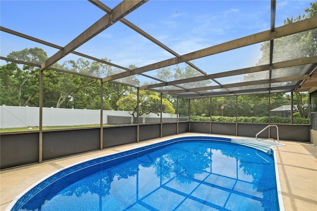 view of pool featuring glass enclosure