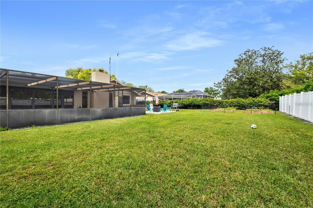 view of yard with glass enclosure