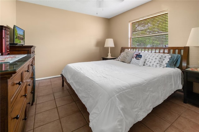 bedroom featuring ceiling fan and dark tile patterned floors