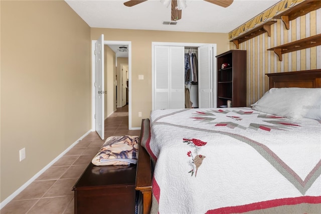 bedroom with a closet, ceiling fan, and tile patterned floors