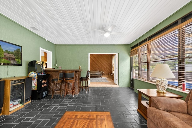 interior space featuring ceiling fan and indoor bar