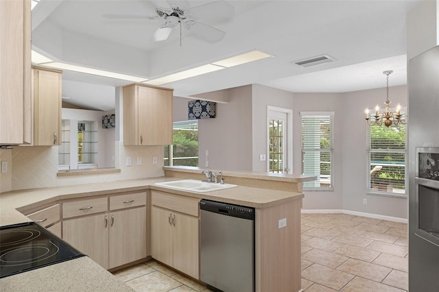 kitchen with stainless steel dishwasher, kitchen peninsula, sink, and light brown cabinetry