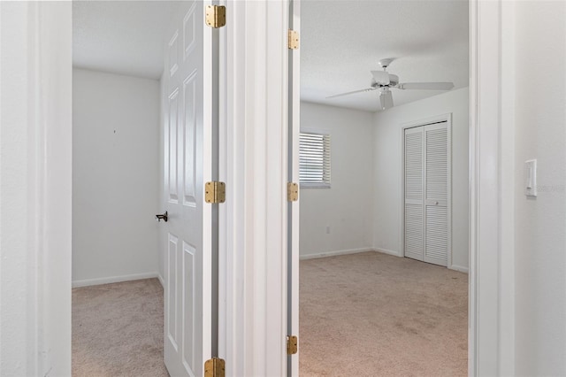 corridor with light colored carpet