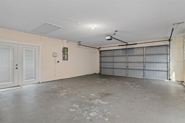 garage featuring electric panel and a garage door opener