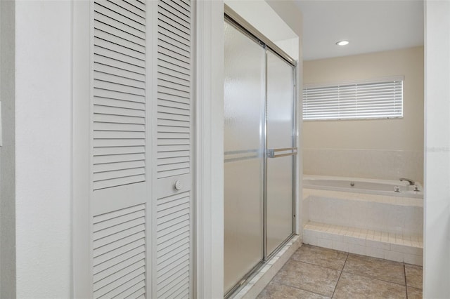 bathroom featuring independent shower and bath and tile patterned flooring