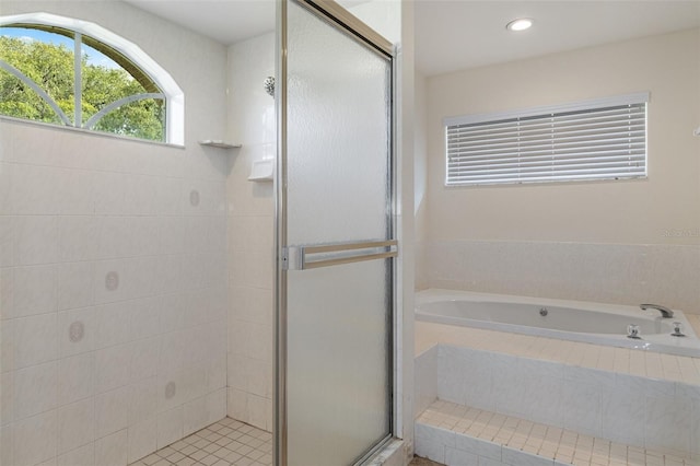 bathroom featuring independent shower and bath