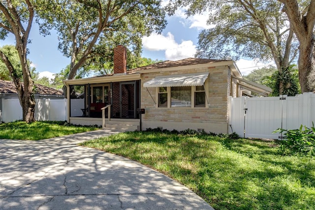 bungalow-style house with a front yard