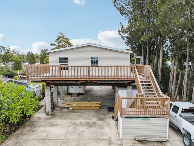 14904 Old Dixie Hwy, Hudson, FL 34667 - rear view of property featuring concrete driveway, a carport, a deck, and stairs