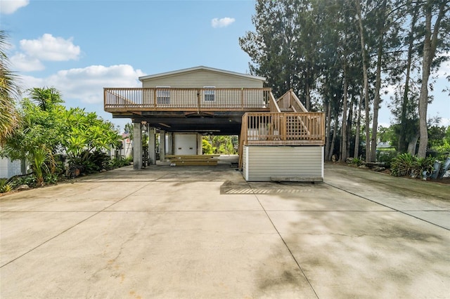14904 Old Dixie Hwy, Hudson, FL 34667 - view of front of home with concrete driveway, a carport, a deck, and stairs