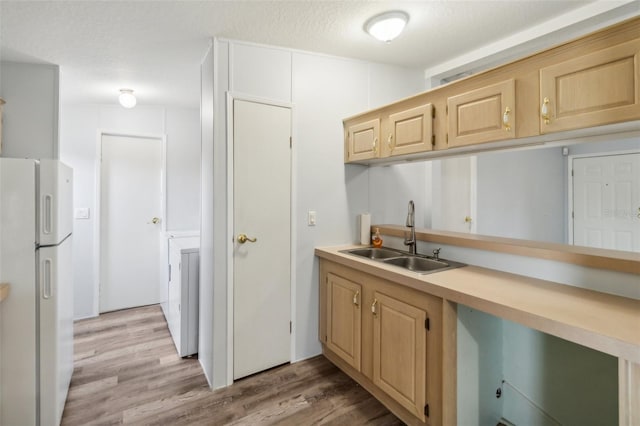 14904 Old Dixie Hwy, Hudson, FL 34667 - kitchen featuring light brown cabinets, light countertops, a sink, and freestanding refrigerator