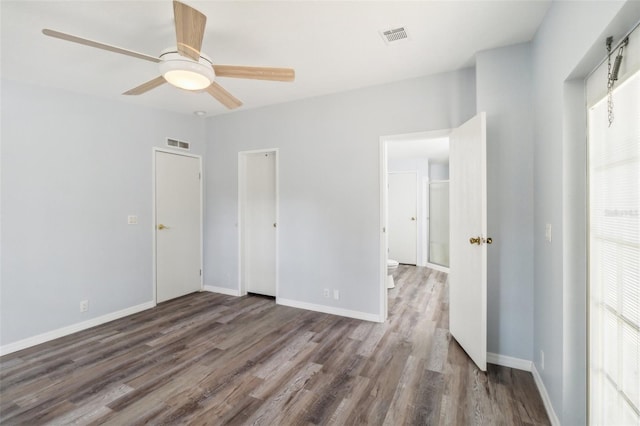 14904 Old Dixie Hwy, Hudson, FL 34667 - unfurnished bedroom featuring wood finished floors, baseboards, ceiling fan, and visible vents