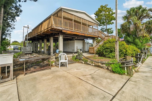 14904 Old Dixie Hwy, Hudson, FL 34667 - back of property featuring stairs, a deck, and a patio area